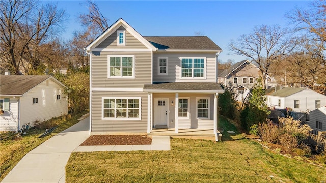 front of property featuring covered porch and a front yard