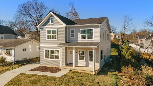 view of property with a front yard, a porch, and central air condition unit