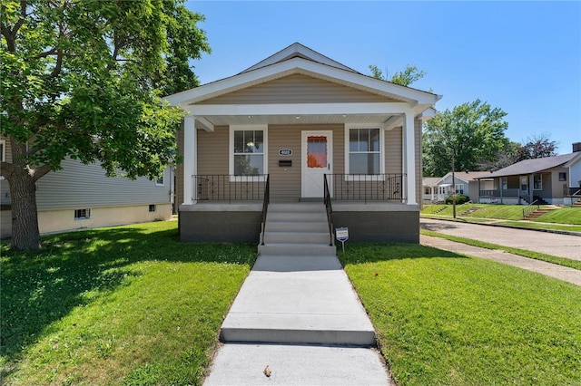 bungalow-style house featuring a porch and a front yard