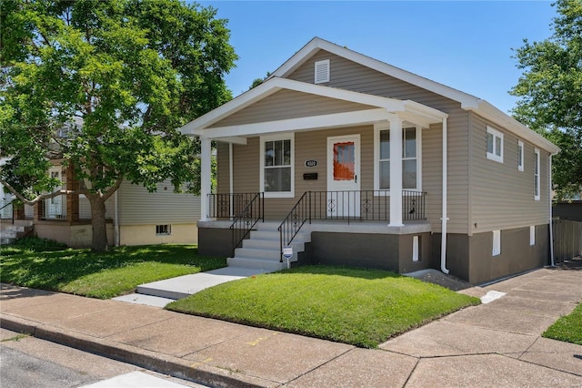 view of front of property with a front yard and a porch