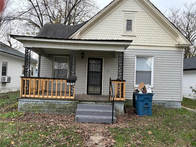 view of front of home with cooling unit and covered porch