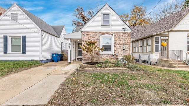 view of front of house with brick siding and a front lawn