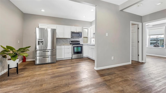 kitchen featuring decorative backsplash, appliances with stainless steel finishes, dark wood-style flooring, light countertops, and white cabinetry