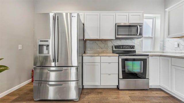 kitchen with light countertops, appliances with stainless steel finishes, and white cabinetry