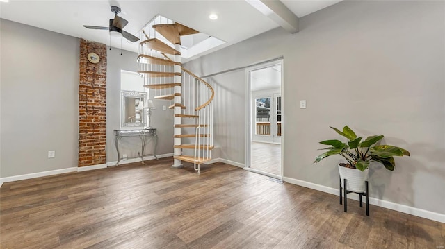 unfurnished room with dark wood-style flooring, beamed ceiling, stairway, and baseboards