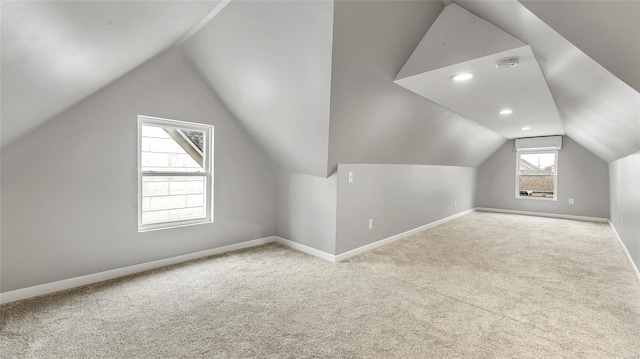 bonus room with light carpet, baseboards, vaulted ceiling, a wall mounted AC, and recessed lighting