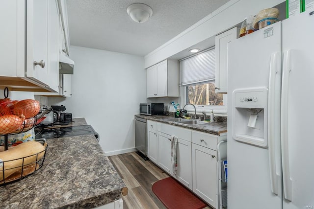 kitchen with white cabinetry, sink, dark hardwood / wood-style floors, and appliances with stainless steel finishes