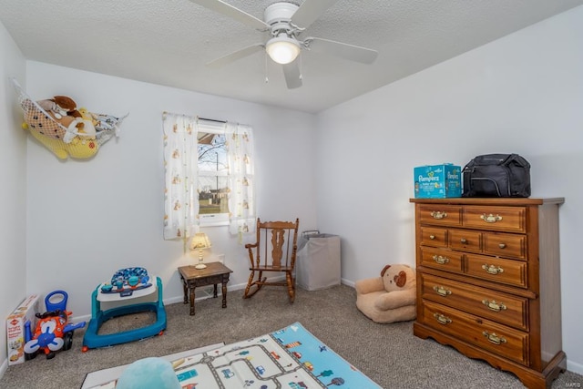 carpeted bedroom featuring a textured ceiling and ceiling fan