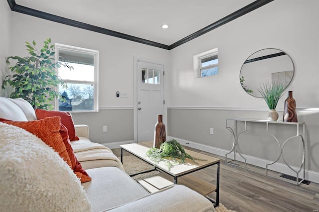 living room featuring crown molding and hardwood / wood-style flooring