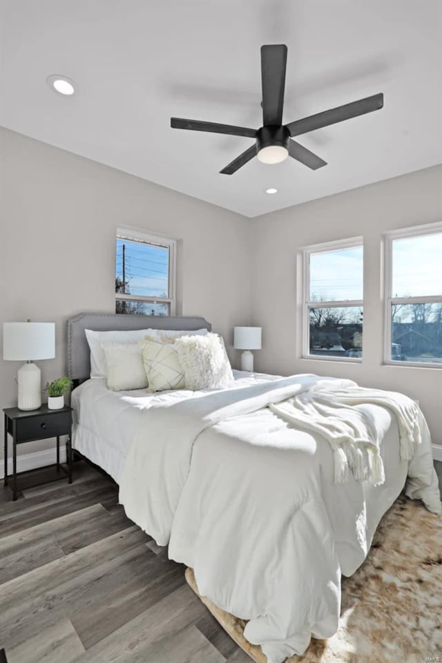 bedroom with ceiling fan and dark wood-type flooring