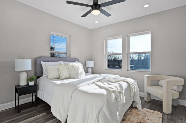 bedroom with ceiling fan and dark hardwood / wood-style floors