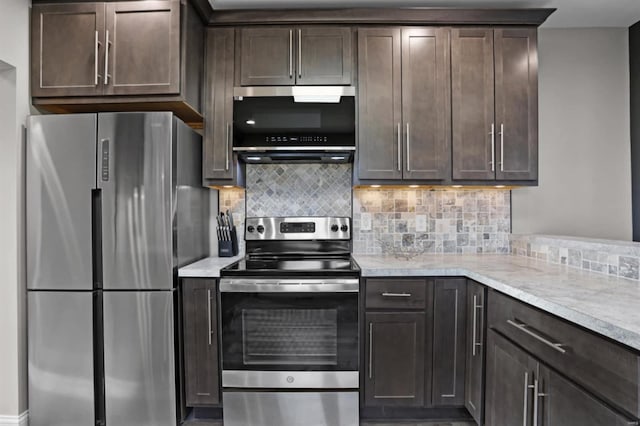 kitchen featuring tasteful backsplash, light stone countertops, dark brown cabinets, and stainless steel appliances