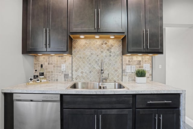 kitchen with dishwasher, dark brown cabinets, tasteful backsplash, and sink