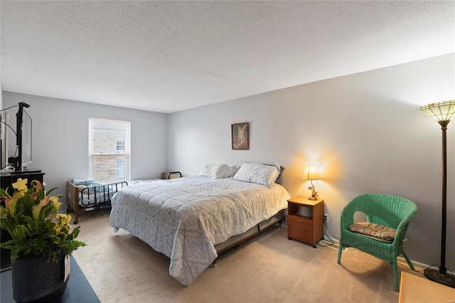 bedroom featuring light carpet and a textured ceiling