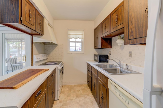 kitchen featuring ventilation hood, white appliances, backsplash, and sink