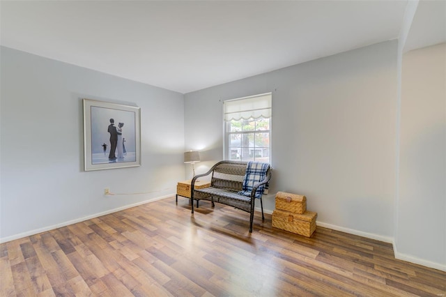 sitting room with hardwood / wood-style flooring