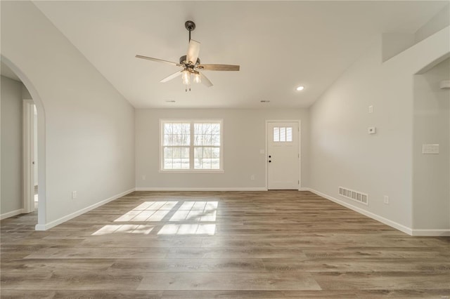 interior space featuring light wood-type flooring, vaulted ceiling, and ceiling fan