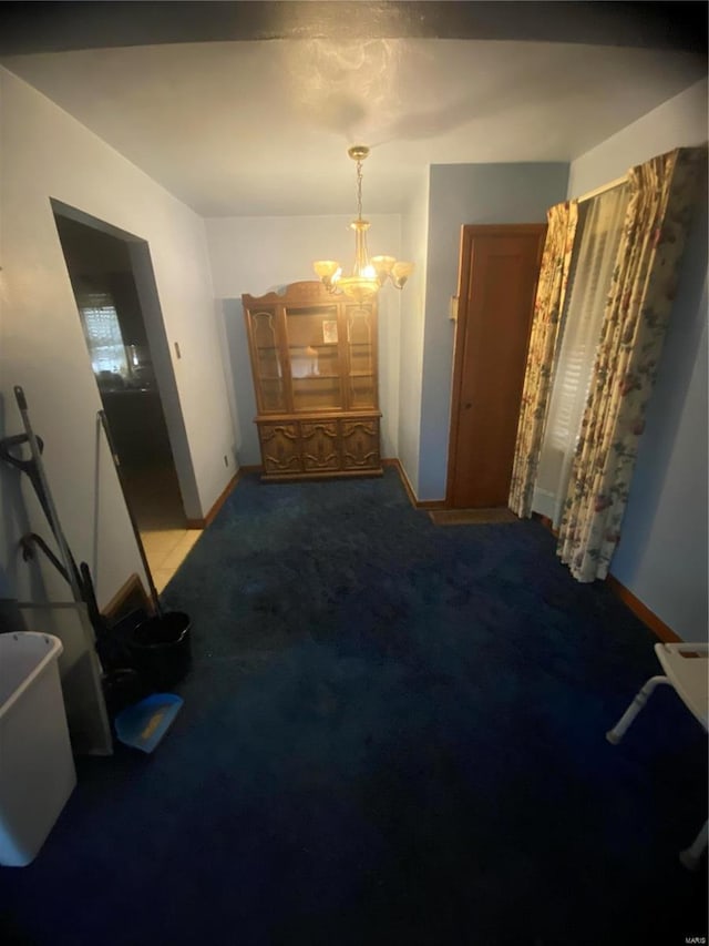 carpeted dining room with a notable chandelier