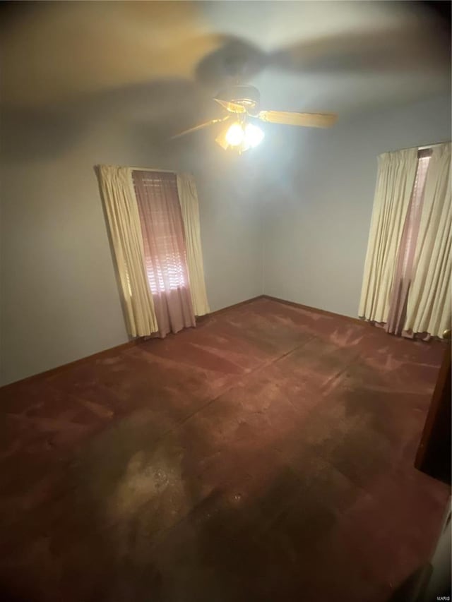 spare room with ceiling fan and carpet floors