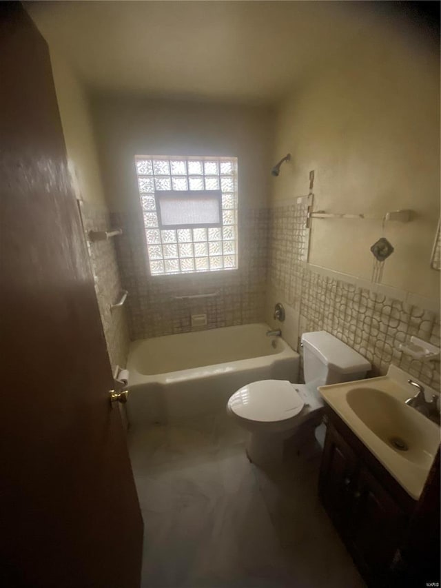 full bathroom featuring vanity, toilet, and tiled shower / bath combo