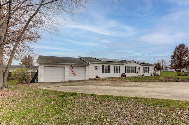 single story home featuring solar panels, a front lawn, and a garage