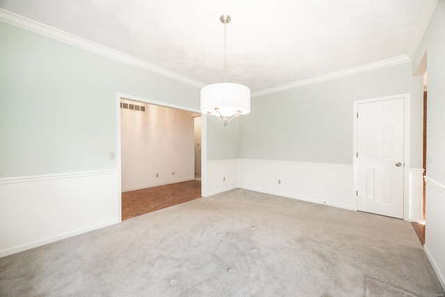 spare room featuring carpet and crown molding