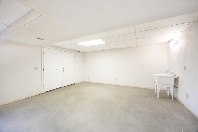 basement with a paneled ceiling