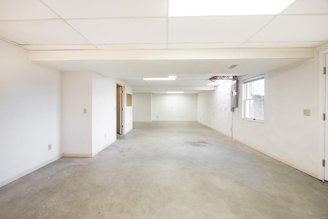 basement with a paneled ceiling