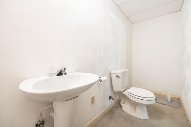 bathroom with toilet and concrete floors