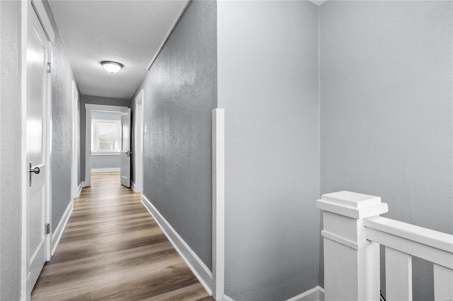 hallway with hardwood / wood-style floors