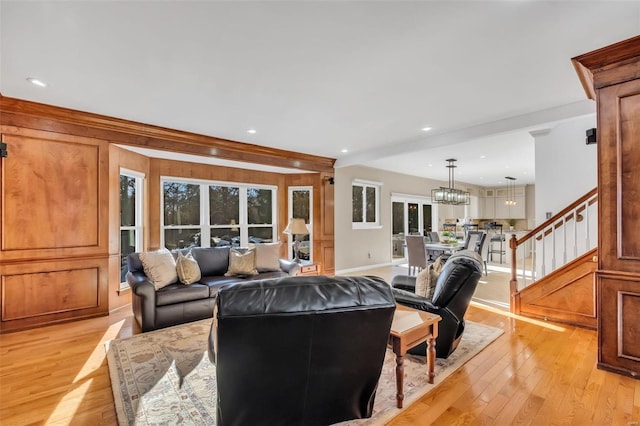 living room with light wood-type flooring and a chandelier