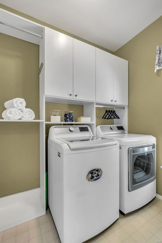 laundry area with cabinets and washing machine and dryer