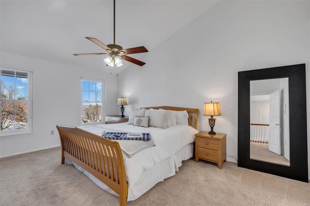 bedroom featuring vaulted ceiling, ceiling fan, and light colored carpet