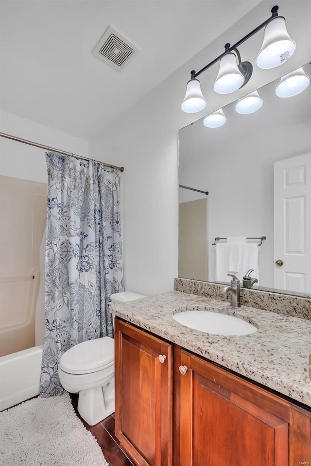 full bathroom featuring toilet, shower / tub combo, and vanity