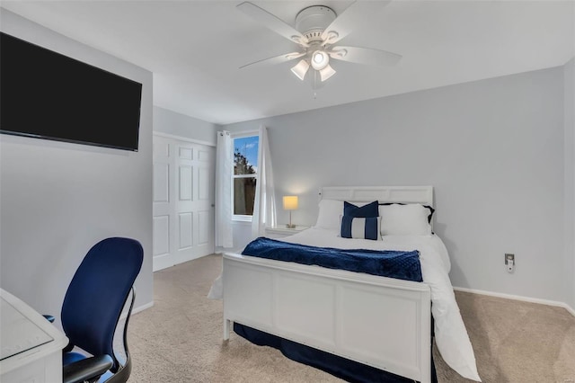 carpeted bedroom featuring ceiling fan and a closet