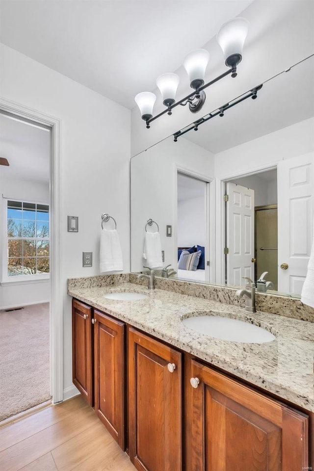 bathroom featuring hardwood / wood-style flooring and vanity