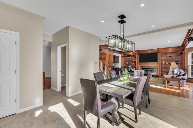 dining space featuring built in features, ornamental molding, a chandelier, and light tile patterned flooring