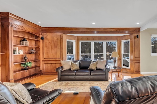 living room featuring light wood-type flooring and built in features