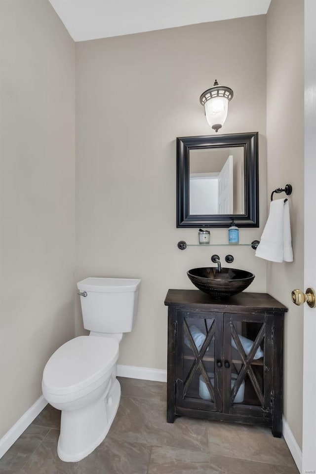 bathroom featuring toilet and vanity