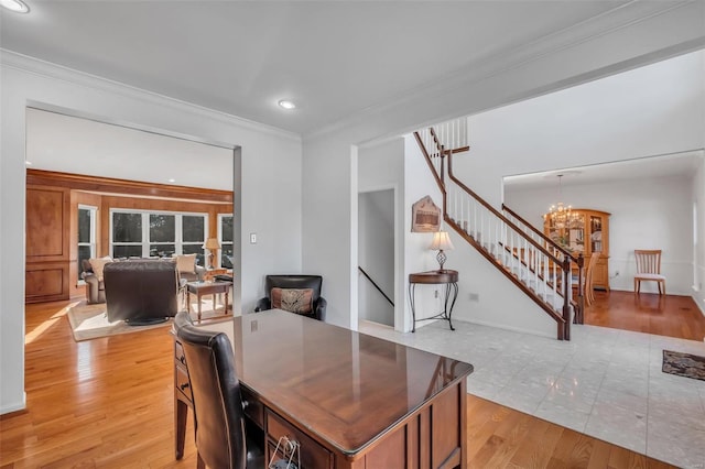 office space featuring crown molding, a chandelier, and light wood-type flooring