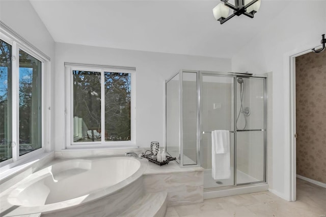 bathroom featuring lofted ceiling and independent shower and bath