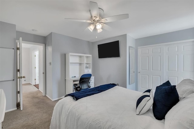 carpeted bedroom featuring ceiling fan and a closet