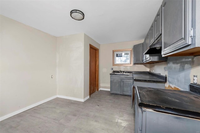 kitchen featuring gray cabinetry and sink