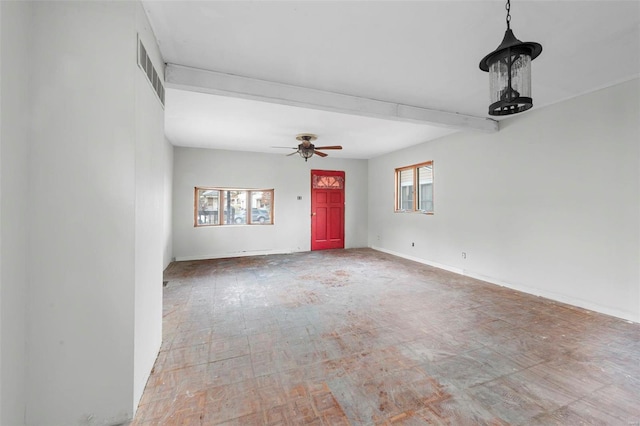 interior space featuring plenty of natural light, ceiling fan, and beam ceiling