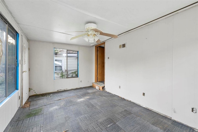 unfurnished room with ceiling fan and carpet floors