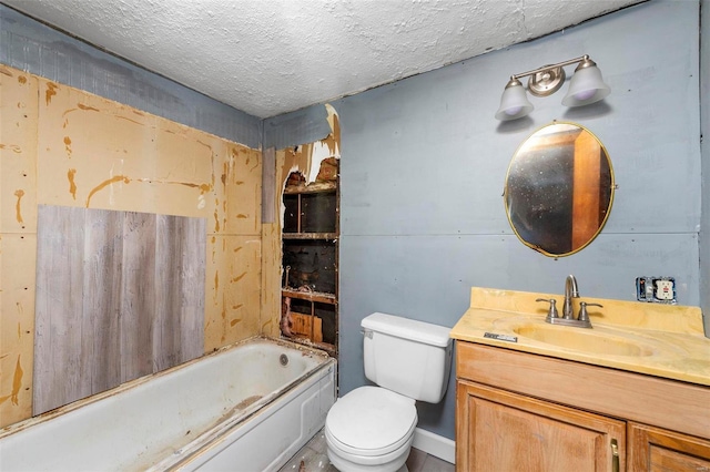 bathroom featuring vanity, a bath, a textured ceiling, and toilet