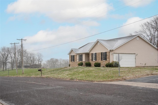 ranch-style home with a front yard and a garage