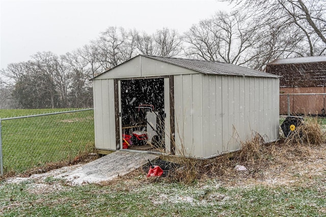 view of outbuilding featuring a lawn