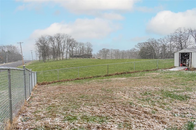 view of yard featuring a rural view and a shed