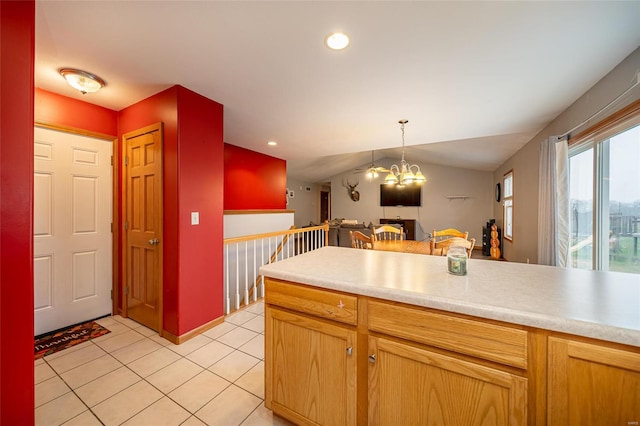 kitchen with a notable chandelier, light tile patterned flooring, lofted ceiling, and decorative light fixtures